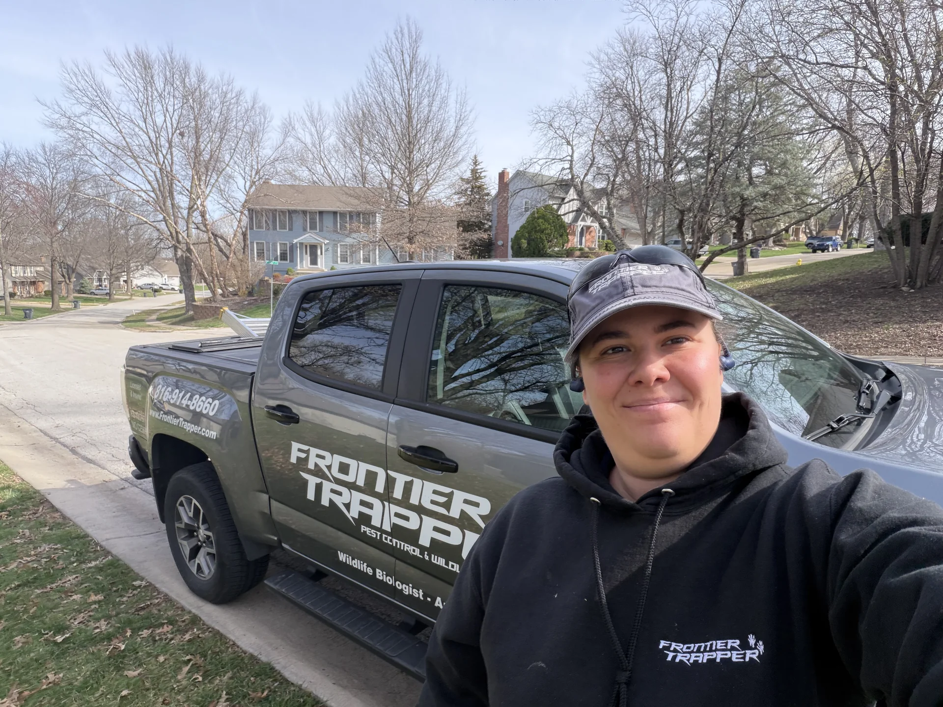 Frontier Trapper technician beside a service vehicle